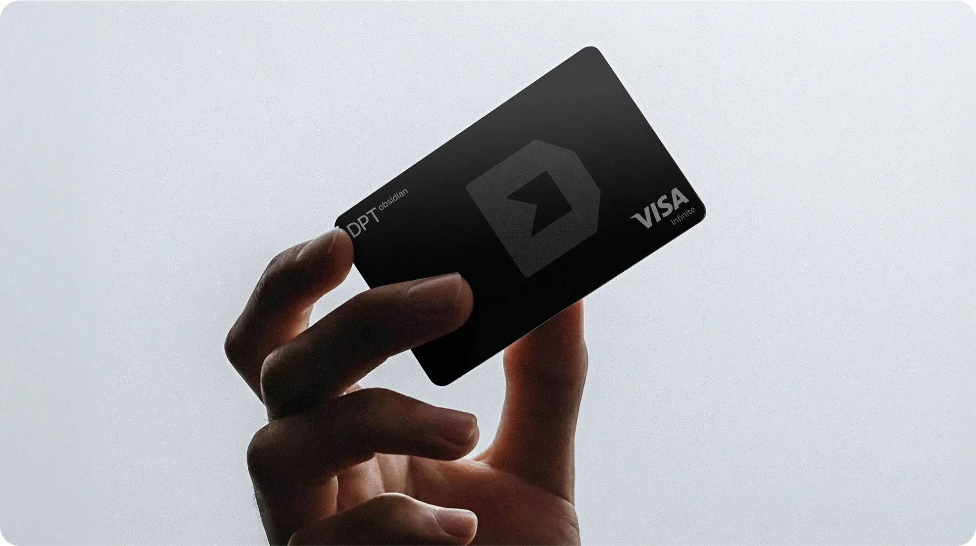 Hand holding a DPT Visa card